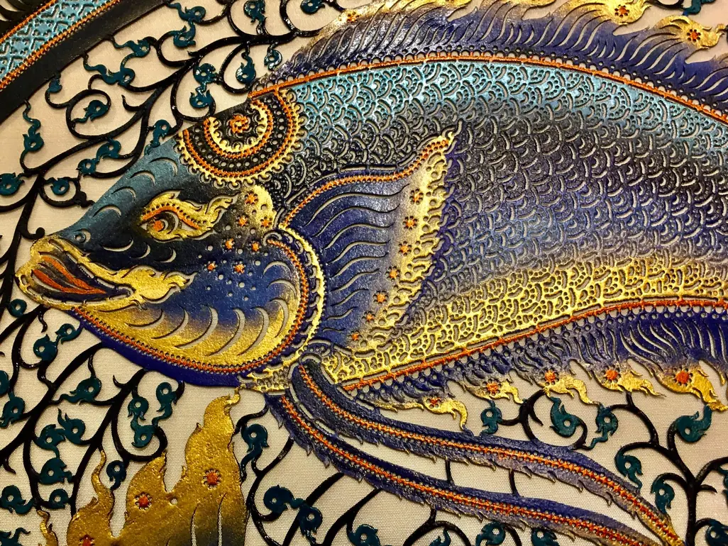 Closer: the fish's head, painted blue and lined in gold
