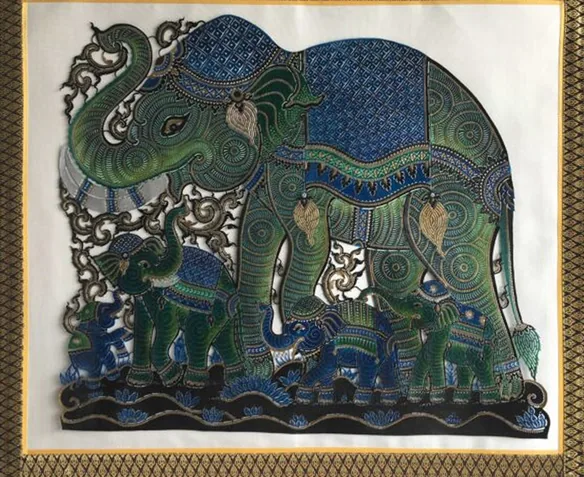 Lucky Elephant: a green elephant in a blue cloth, with small elephants at its feet